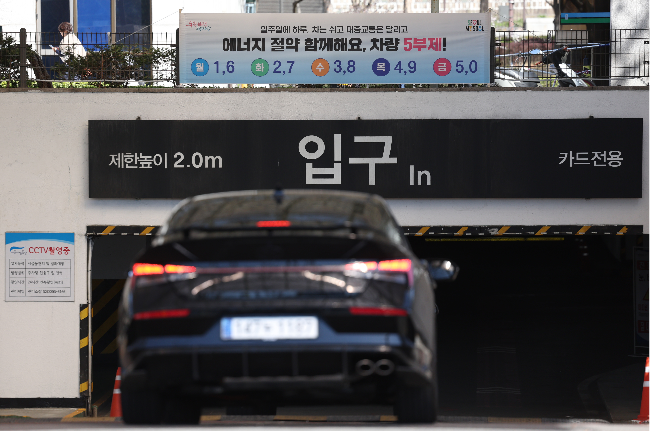 A banner on the launch of a 1 in 5 rotation system is posted at the entrance to Jongmyo Public Parking Lot in Seoul on Tuesday. (Yonhap)