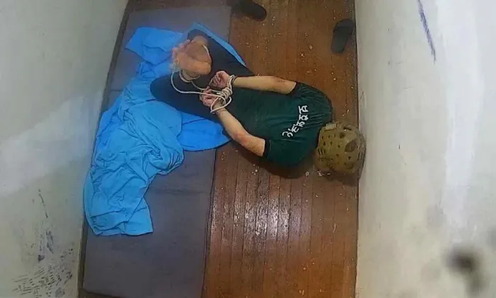 A Moroccan man is kept on his stomach with his feet and hands tied behind his back in solitary confinement at Hwaseong Immigration Detention Center in Gyeonggi Province in 2021. (Duroo Association for Public Interest Law)