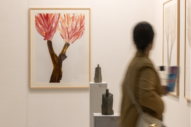 A woman walks past a booth at the Galleries Art Fair at Coex in southern Seoul on Wednesday. (Galleries Association of Korea)