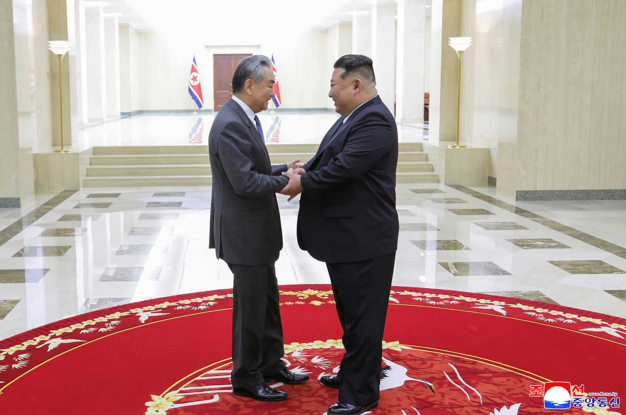 Kim Jong-un (right) meets with Chinese Foreign Minister Wang Yi in Pyongyang on Friday, in this photo carried by the North's official Korean Central News Agency the following day. (Yonhap)