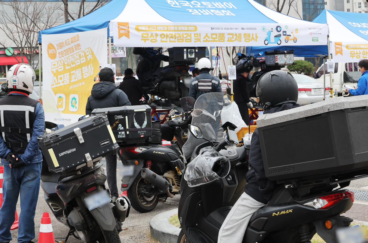 This photo of delivery workers having their motorcycles inspected in Suwon, Gyeonggi Province, is not directly related to this article. (Yonhap)