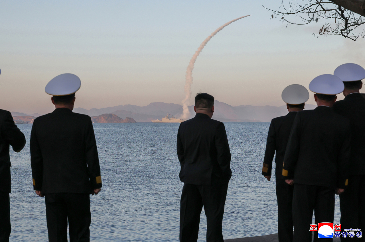 North Korean leader Kim Jong-un (third from right) observes another missile test launch conducted from its new naval destroyer Choe Hyon. (KCNA via Yonhap)