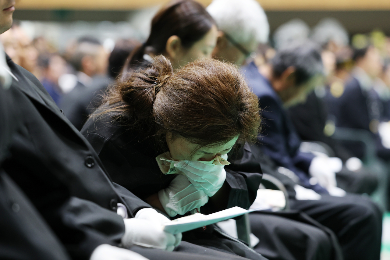 A bereaved family member breaks down in tears during a funeral service for the late Senior Fire Lt. Park Seung-won and Fire Sgt. Noh Tae-young at the Wando Agricultural and Fisheries Cultural and Sports Center in South Jeolla Province on Tuesday morning. (Yonhap)