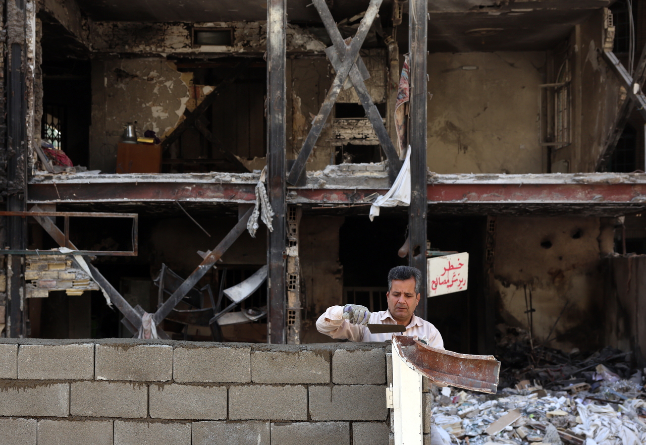 An Iranian worker works on a damaged residential building which was destroyed by US-Israeli airstrikes at the Shahid Broujerdi residential complex in southern Tehran, Iran, Tuesday.   EPA-Yonhap