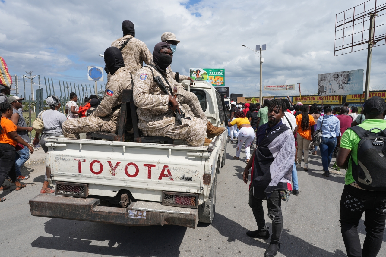 National Police patrol alongside a march in Port-au-Prince, Haiti, Monday. (AP-Yonhap)