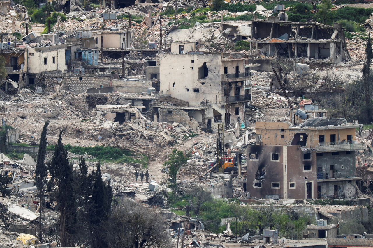 Israeli soldiers stand among destroyed buildings in southern Lebanon, Tuesday. (Reuters-Yonhap)