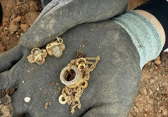 Recovered necklace and earrings believed to belong to a victim of the 2024 Jeju Air crash are seen during a search operation at Muan International Airport. (Courtesy of the bereaved families’ association via Yonhap)