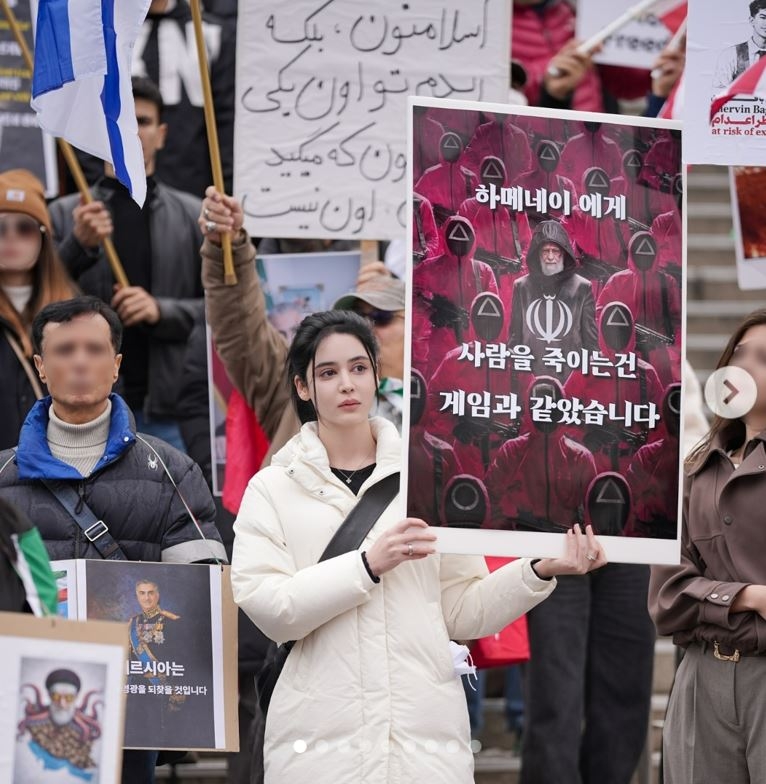 This photo posted by Hoda Niku on her Instagram page shows her participating in a rally against the Iranian government. (Instagram)