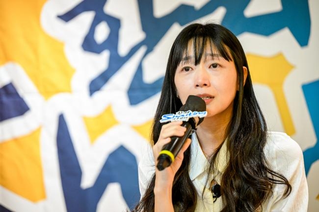 Kim Dong-hee’s mother speaks at an event in 2024 to raise awareness of what happened to her son. (Patient Shouting Cafe/Korea Alliance of Patients Organization)