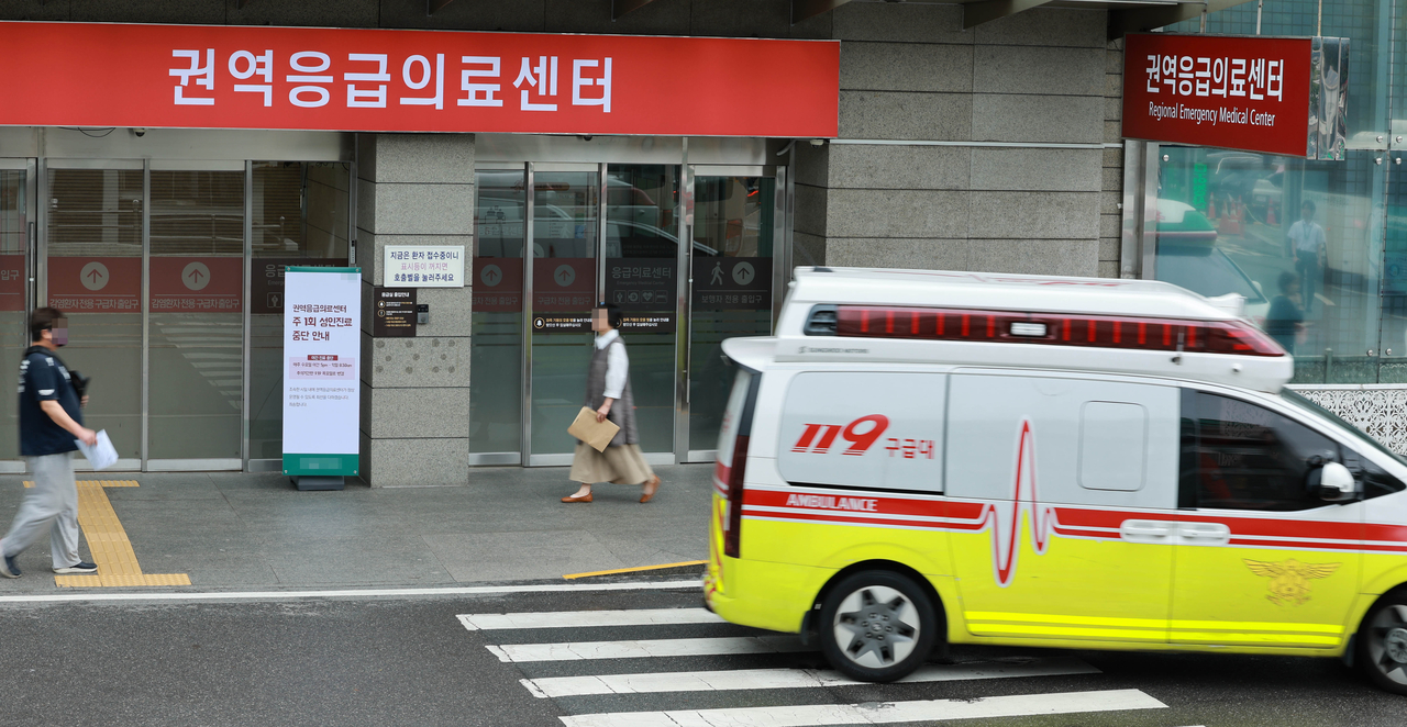An ambulance passes in front of the regional emergency medical center of a university hospital in Seoul in this file photo from 2024. (Newsis)