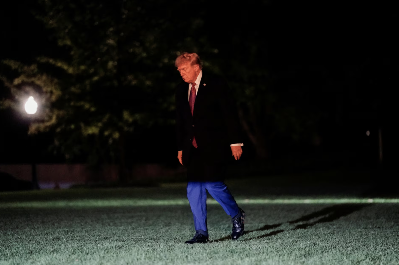 US President Donald Trump walks after exiting Marine One on the South Lawn while returning to the White House in Washington, Friday. (Reuters via Yonhap)