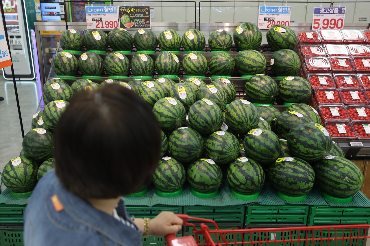 A shopper passes watermelons on display at a supermarket in Seoul on Sunday. (Yonhap)