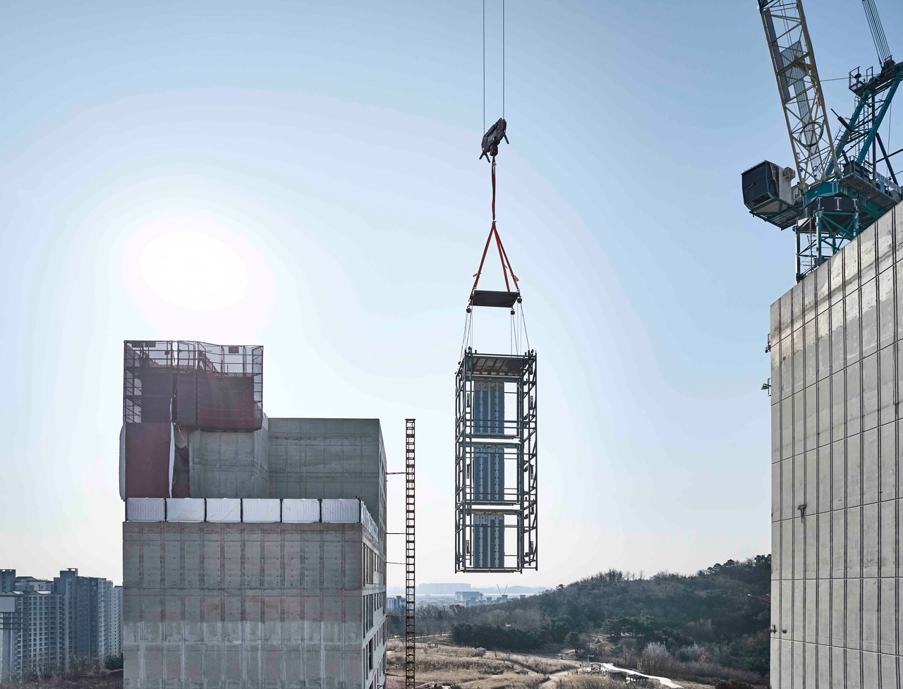 Three ENOBLOC modules are being stacked at the Hillstate Center Park construction site in Songdo, Incheon. (Hyundai Elevator)