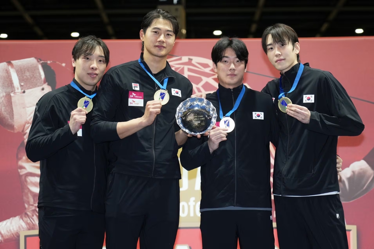 From left: Park Sang-won, Oh Sang-uk, Im Jae-yoon, and Do Kyung-dong pose for photos after winning the gold medal in the men's sabre team event at the Padova World Cup in Italy on Sunday.    KFA