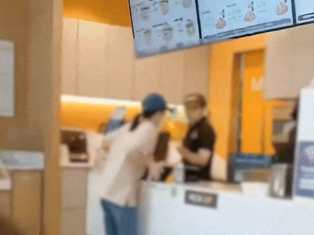 A woman causes a disturbance at a burger restaurant in Seoul in footage taken in October. (BobaeDream)