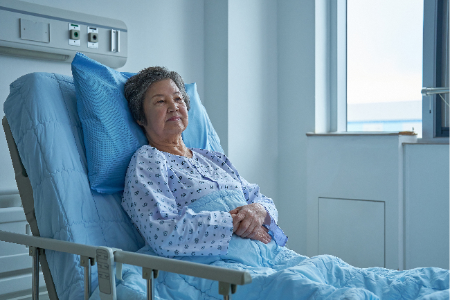 An elderly woman sits in a hospital bed in this file photo. (Getty Images Bank)