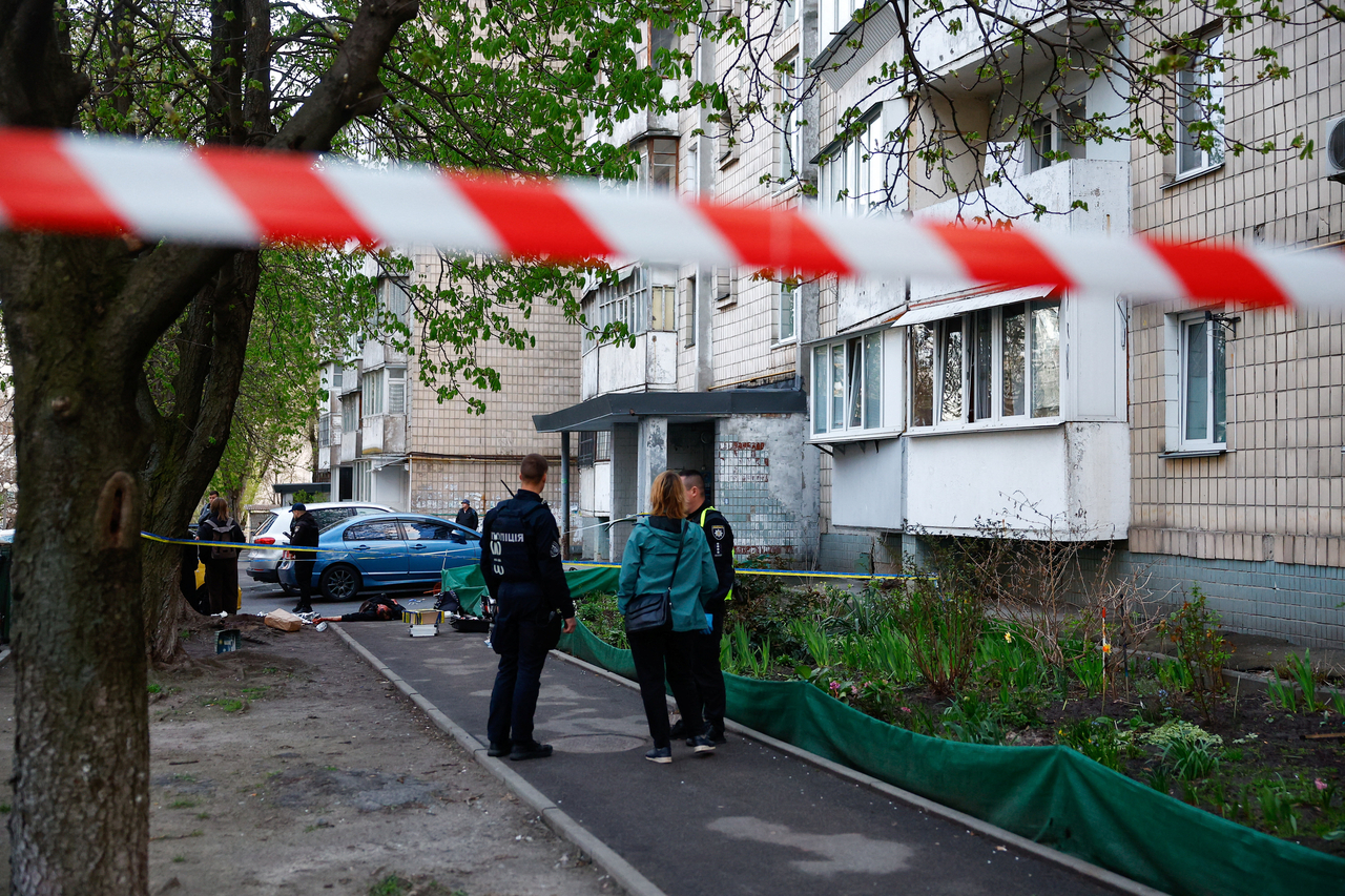 Police work at the site of a shooting incident, as a body lies on the ground, in Kyiv, Ukraine, Saturday. (Reuters-Yonhap)