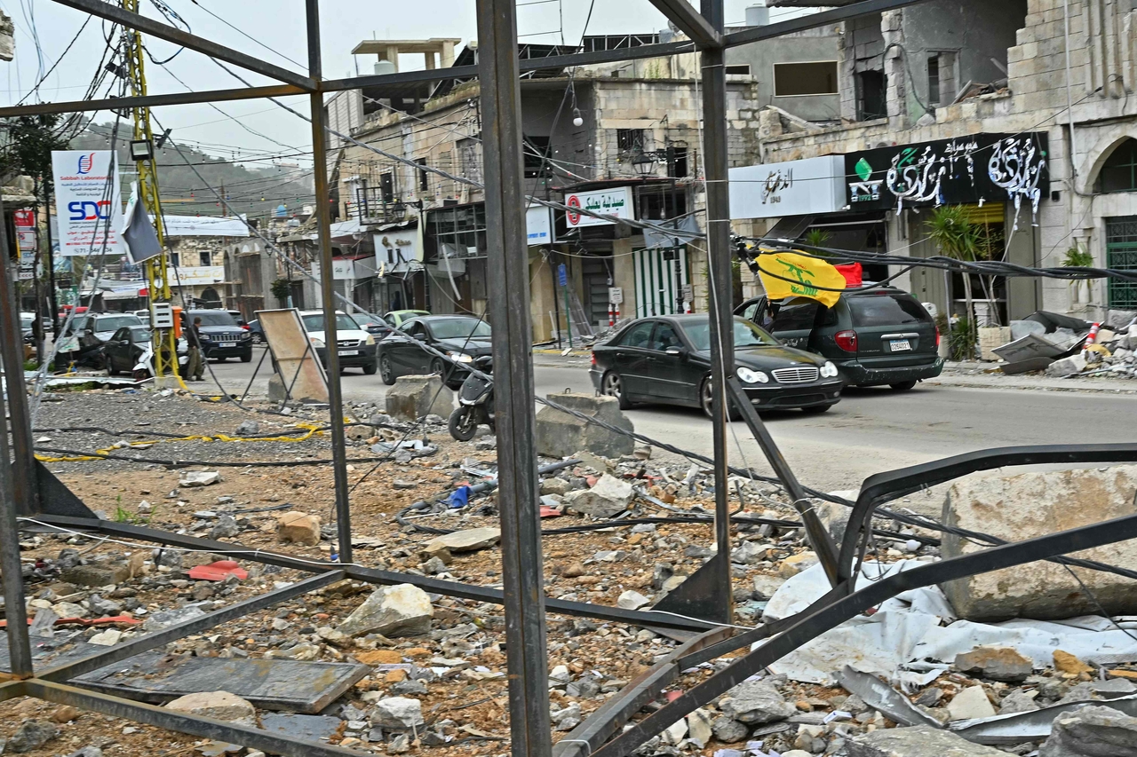 Displaced residents drive past destroyed buildings as they return back to the southern Lebanese city of Nabatieh on Saturday. (AFP-Yonhap)