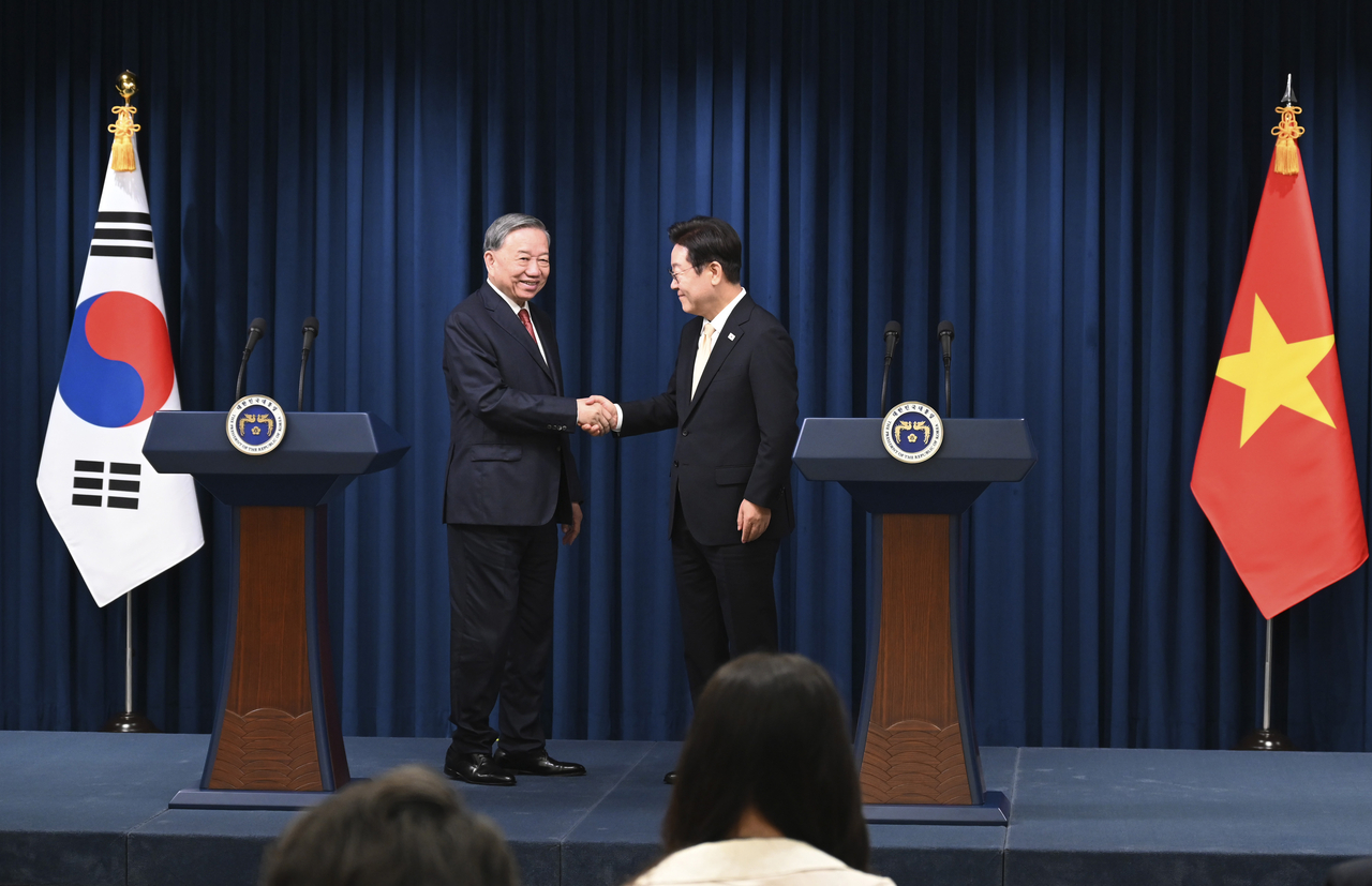 South Korean President Lee Jae Myung (R) shakes hands with General Secretary of the Communist Party of Vietnam To Lam (L) during a joint statement at the presidential office on August 11, 2025 in Seoul, South Korea. (Getty Images)