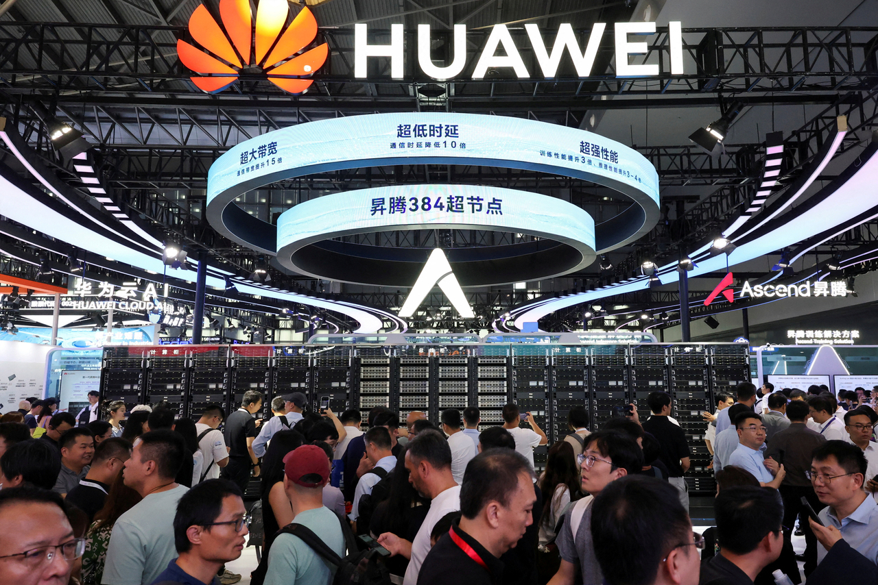 People visit a Huawei booth during the World Artificial Intelligence Conference in Shanghai, China on July 26. (Reuters)