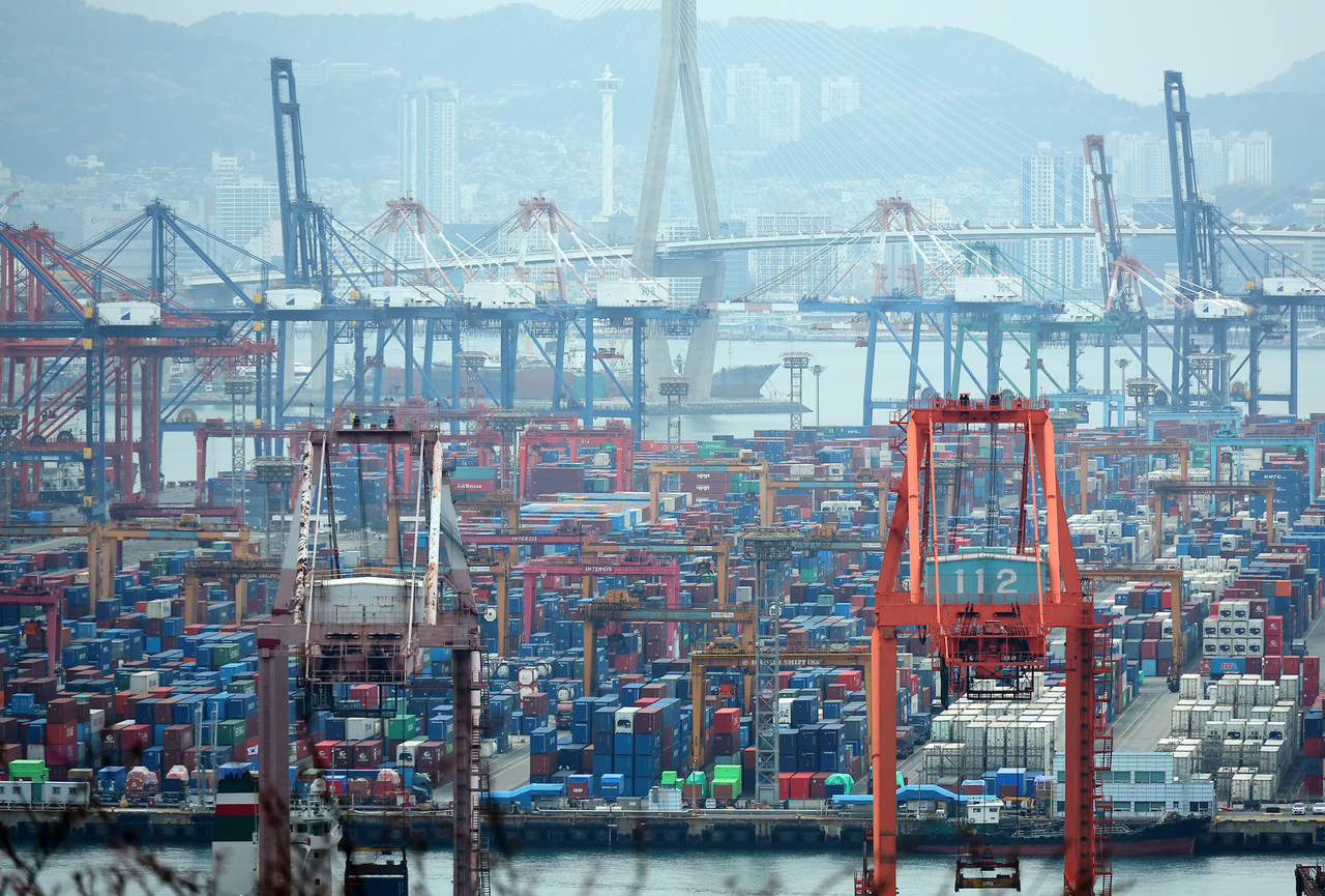 Containers are stacked at a port in Busan on April 1. (Yonhap)