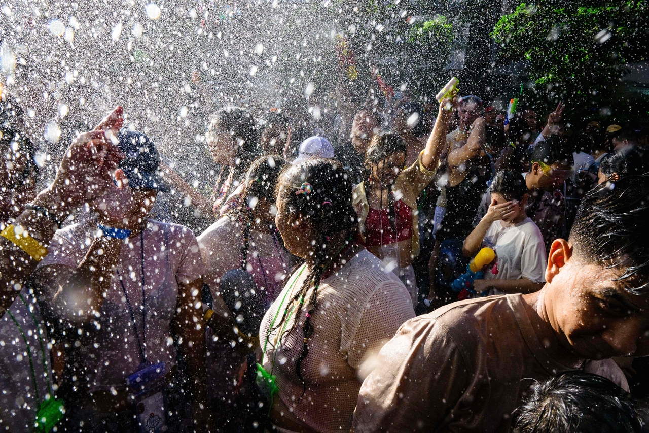 People take part in mass water fights on the first day of Songkran, or Thai New Year, in Bangkok on April 13. (AFP-Yonhap)