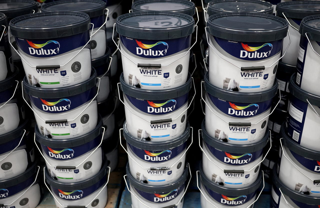Cans of Dulux paint, an AkzoNobel brand, are seen on the shelf of a DIY retail store in Manchester, England, in 2024. (Reuters-Yonhap)