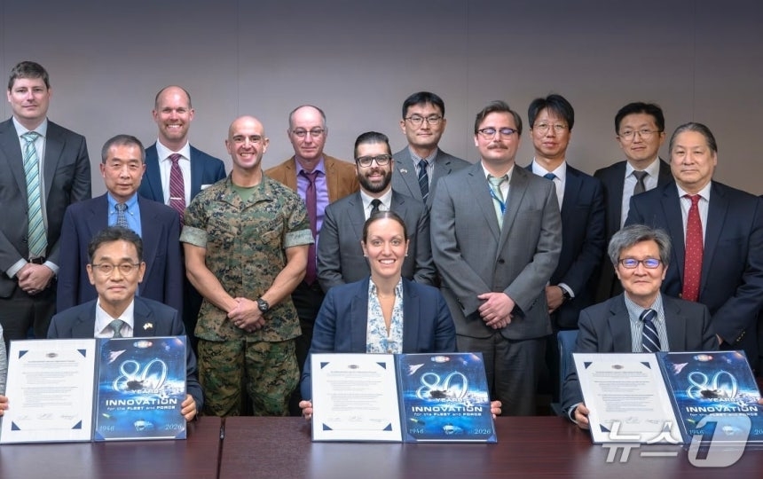 From left in first row: Chang Kwang-pil, head of the Future Technology Institute at HD Korea Shipbuilding & Offshore Engineering; Rachel Riley, director of ONR; and Kim Yong-hwan, professor at Seoul National University, pose for a photo during a contract signing ceremony at ONR headquarters in Arlington, Virginia, on April 23.  (HD Hyundai)