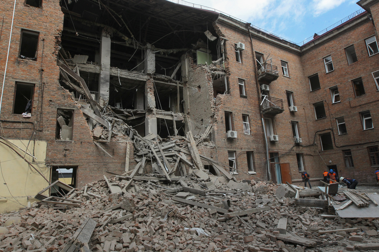 Municipal workers remove debris at the site of a residential building hit during a midday Russian drone strike in Dnipro, Ukraine, Saturday. (Reuters-Yonhap)