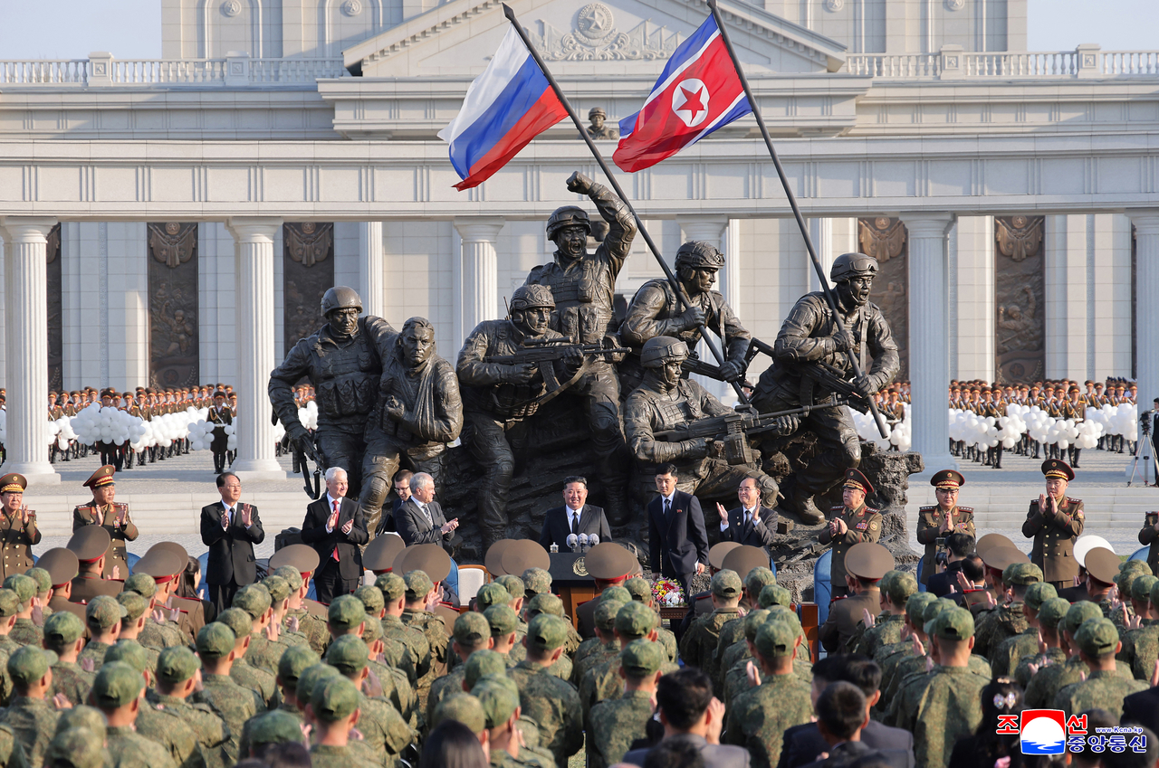 North Korea leader Kim Jung-un (center) speaks at the opening ceremony of the Memorial Museum of Combat Feats at the Overseas Military Operations in Pyongyang on Sunday. (KCNA via Yonhap)