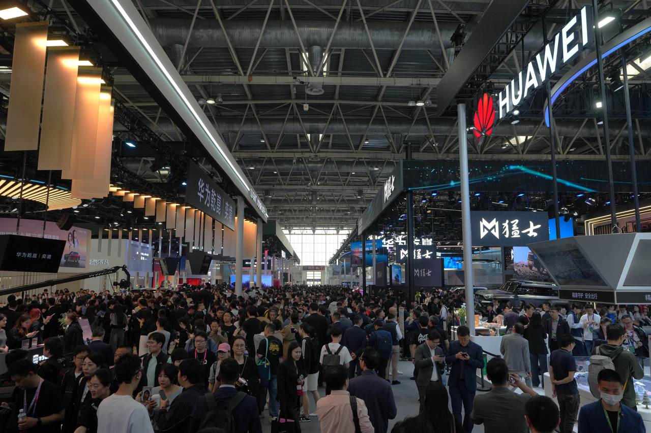 Visitors tour the Huawei exhibition booths showcasing it latest car models at the Auto China 2026 trade show in Beijing, Friday. (AP-)