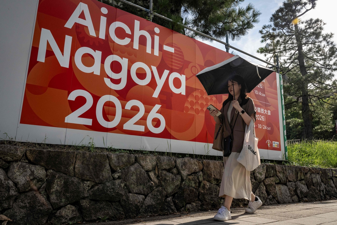 This picture taken on Sept. 8, 2025, shows a pedestrian walking past an advertisement for the 2026 Aichi-Nagoya Asian Games in Nagoya, Aichi prefecture. AFP-Yonhap