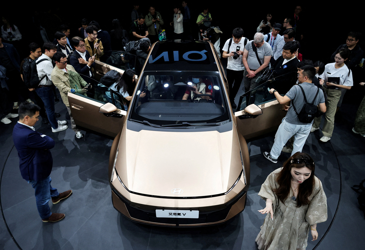 People gather next to the new Ioniq V, newly presented at the Hyundai booth during Auto China in Beijing on Friday. (Reuters-)
