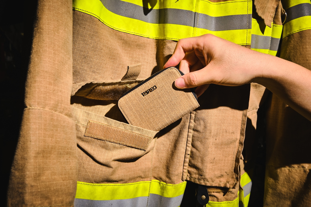 119REO's earliest products, including this wallet, were made by hand-sewing fabric from retired aramid-fiber turnout coats donated by Korean fire stations. (119REO)