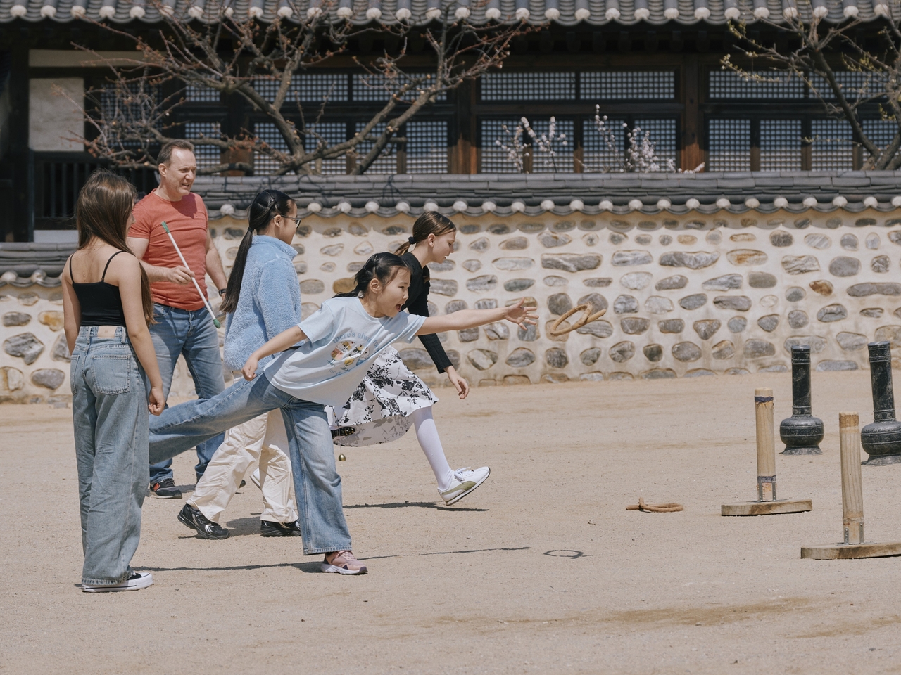Children play a traditional game at the Namsan Hanok Village in this undated photo. (Namsan Hanok Village)