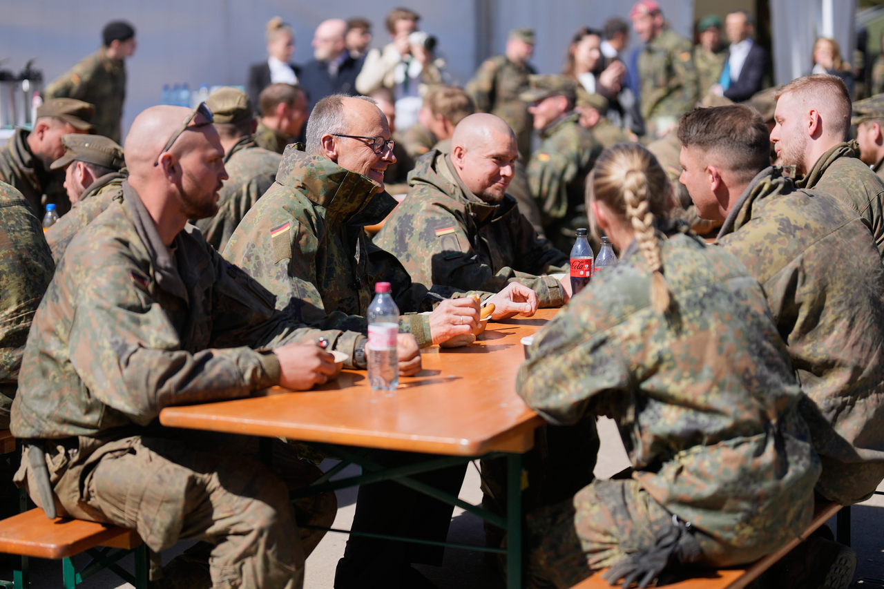 German Chancellor Friedrich Merz (second from left) talks to soldiers during a lunch at the Bundeswehr base in Munster, Germany, Thursday. (AP-Yonhap)