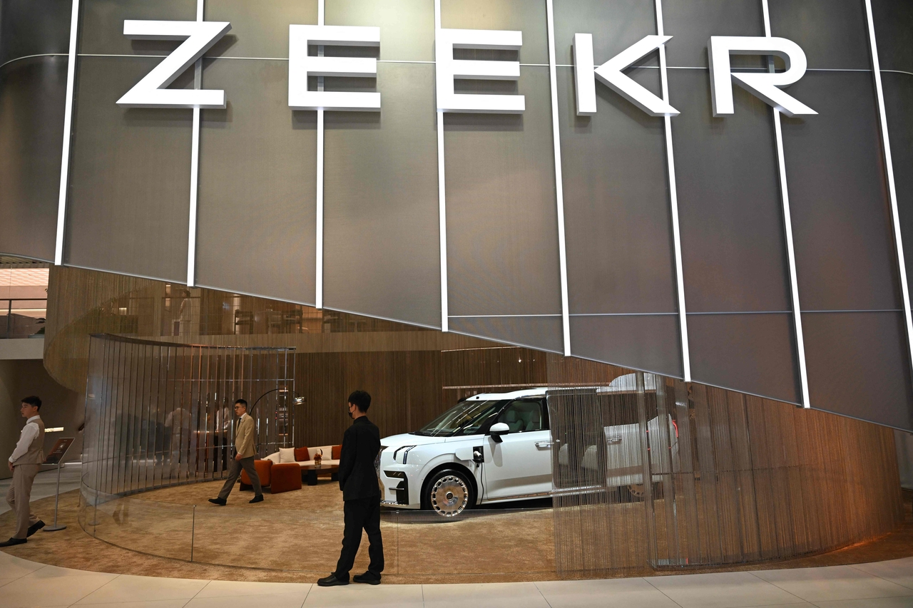 Visitors look at a Zeekr 009 Grand at the Beijing Auto Show in Beijing on April 26. (AFP-Yonhap)