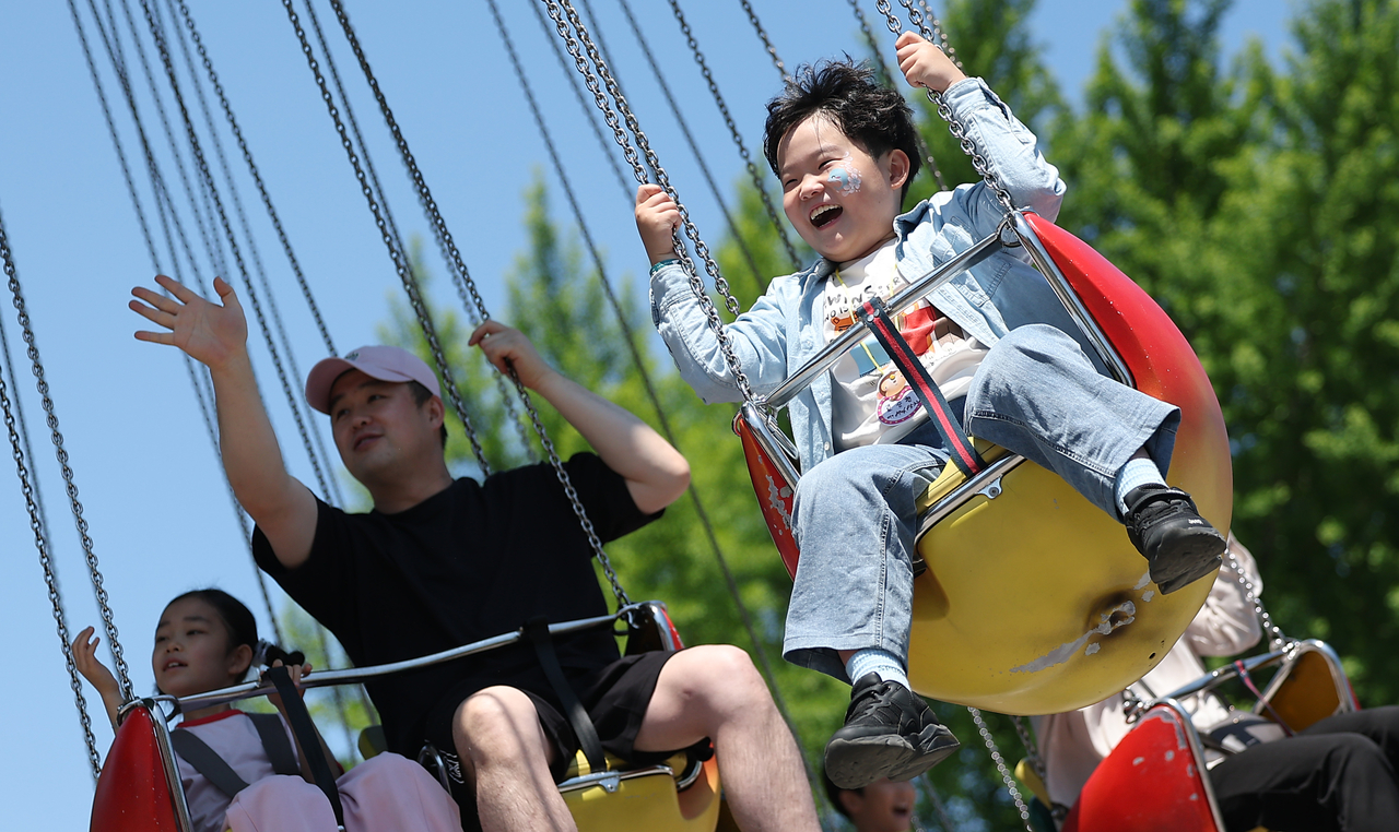 Children and parents ride amusement park attractions at Children’s Grand Park in Gwangjin-gu, Seoul, on Children's Day. (Yonhap)