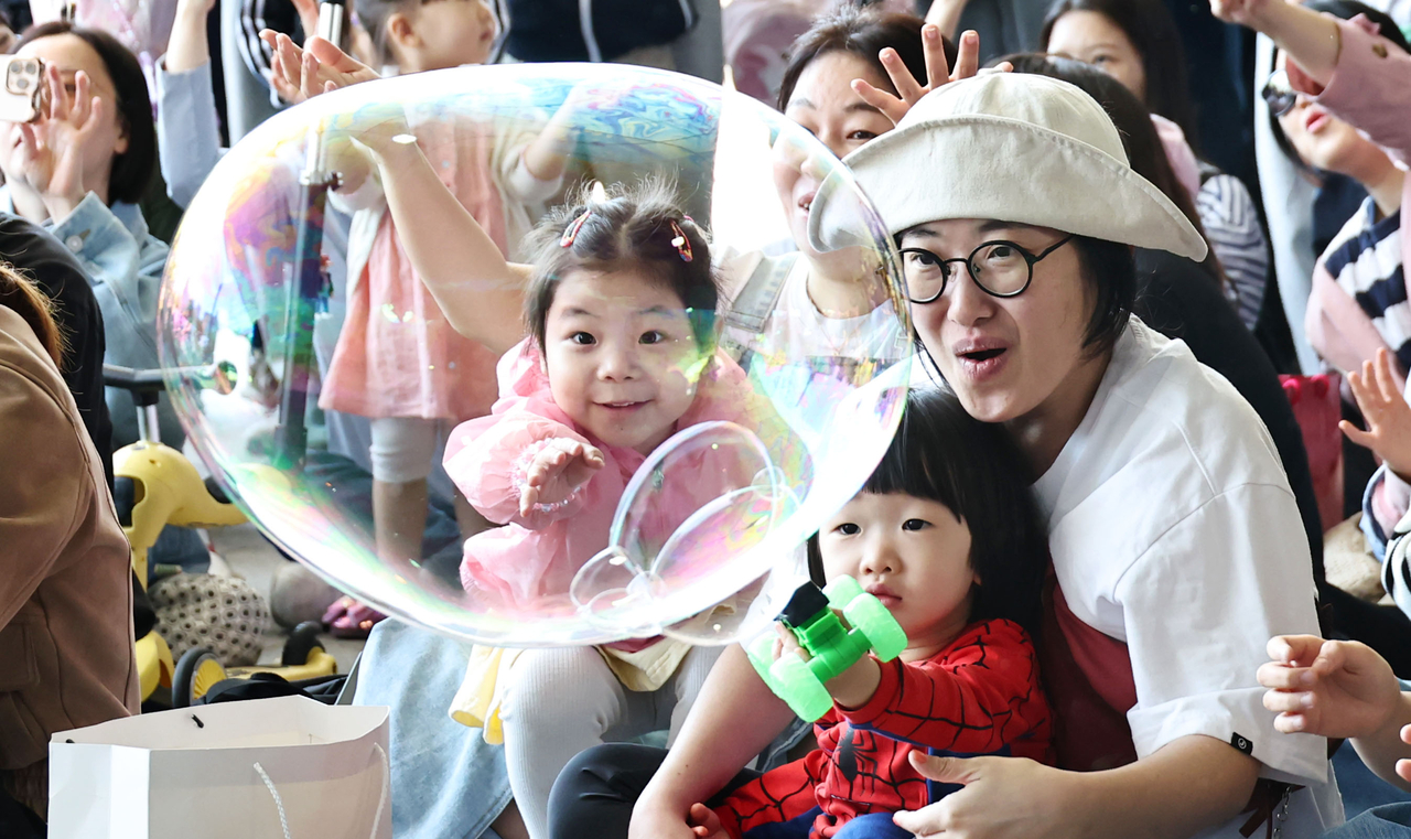Children enjoy the "Bubble Family Play Show" at the 2026 DDP Children’s Design Festival in Seoul on Monday. (Yonhap)