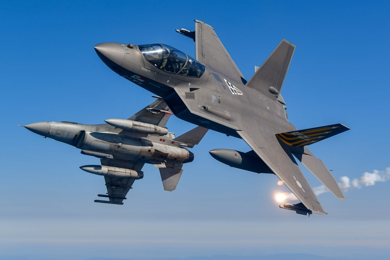South Korea's homegrown supersonic fighter jet KF-21 (right) launches a flare during a test flight alongside a KF-16, Wednesday. (Republic of Korea Air Force)