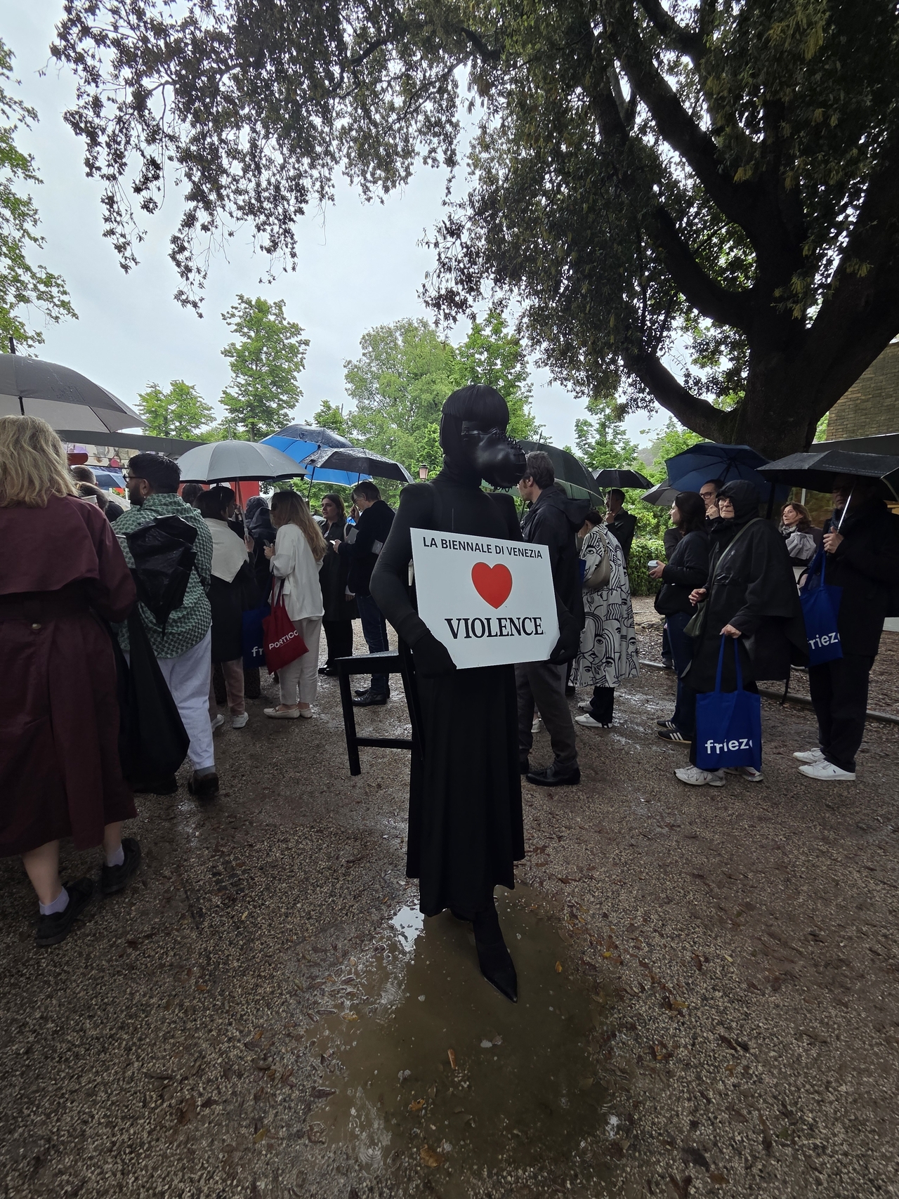 A protester stands near the entrance to the Giardini on Wednesday, the opening day of the 2026 Venice Biennale in Venice, Italy. (Park Yuna/The Korea Herald)