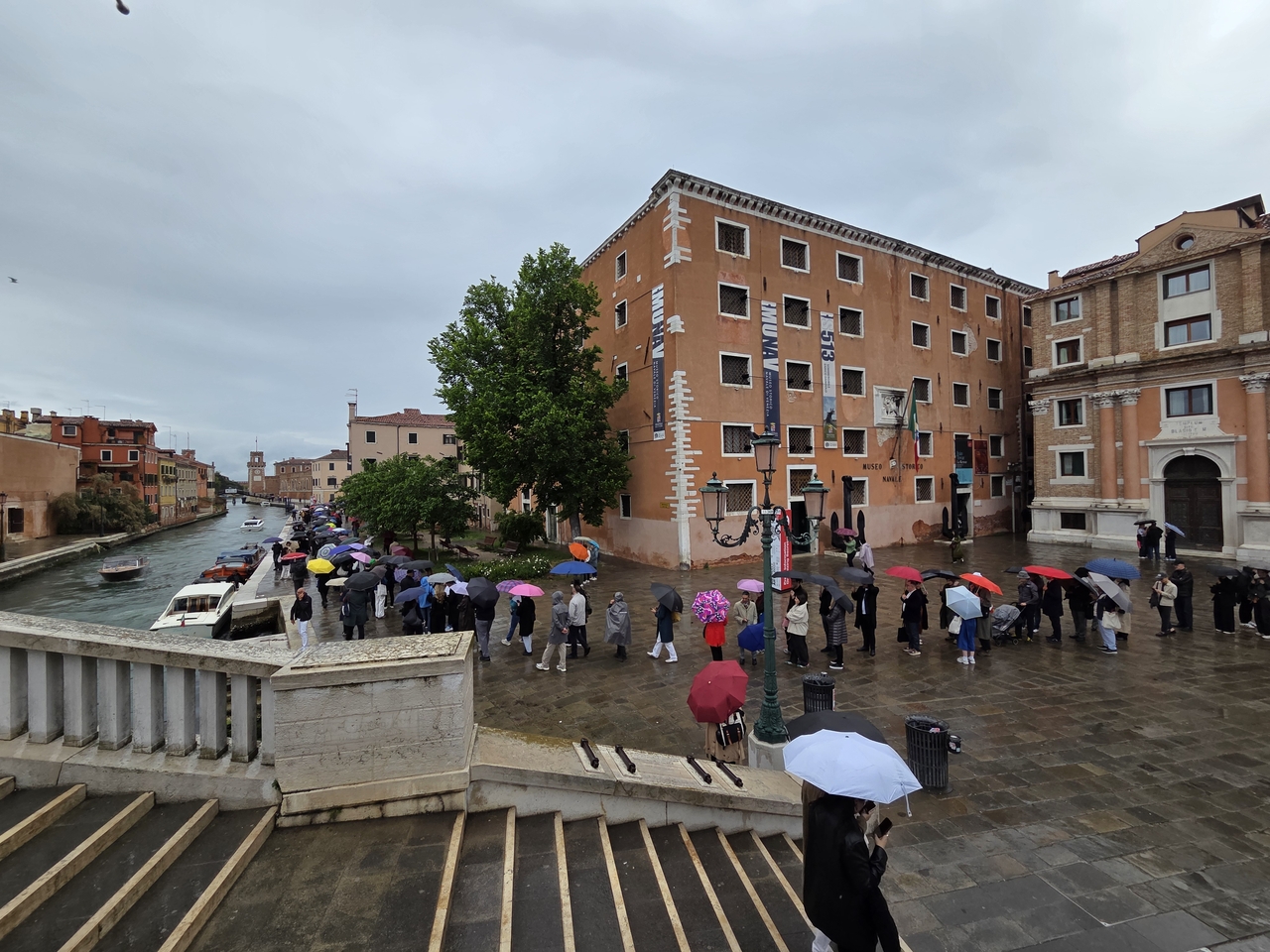 Visitors wait in the rain to enter the exhibition "In Minor Keys" at the Arsenale on Wednesday morning, the opening day of the 2026 Venice Biennale, in Venice, Italy, Wednesday. (Park Yuna/The Korea Herald)