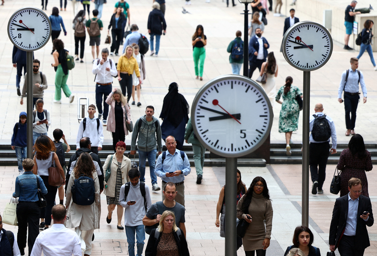 Workers walk through the Canary Wharf financial district in London on Aug. 3, 2023.   Reuters-Yonhap