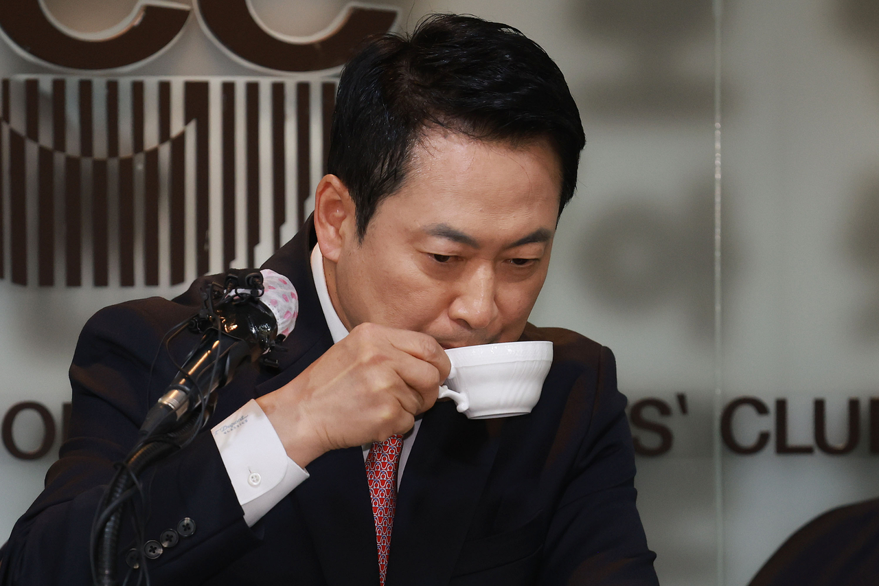 People Power Party Chair Rep. Jang Dong-hyeok sips coffee during a press conference hosted by the Seoul Foreign Correspondents’ Club at the Press Center in central Seoul on Friday. (Pool photo via Yonhap)