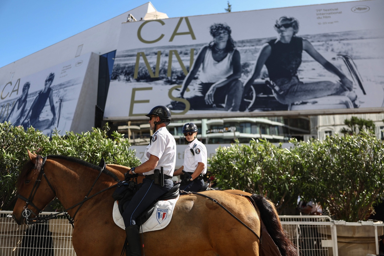 Mounted police officers patrol in front of the Palais du Festival during the opening ceremony of the 79th Cannes Film Festival, Tuesday. (AFP-Yonhap)