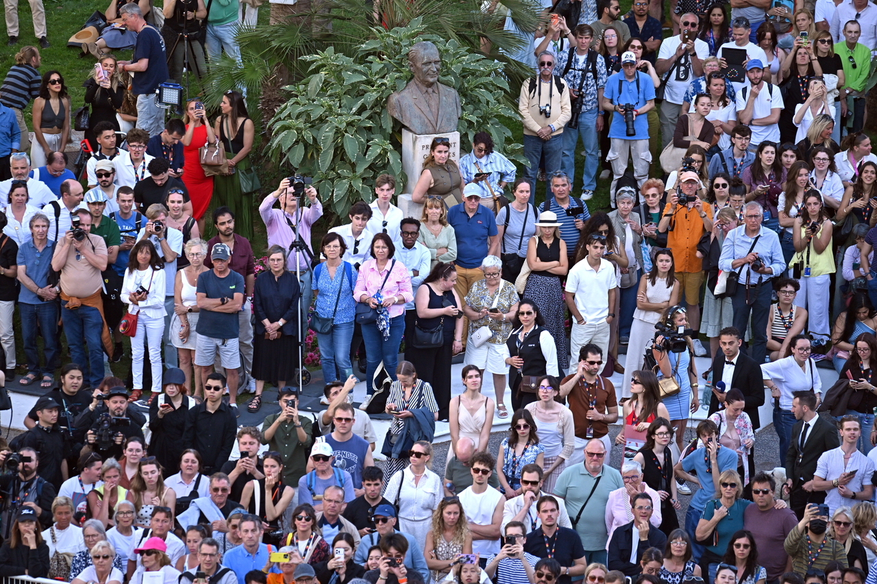 Spectators watch guests walking the red carpet at the opening ceremony of the 79th Cannes Film Festival in France on Tuesday. (EPA-Yonhap)