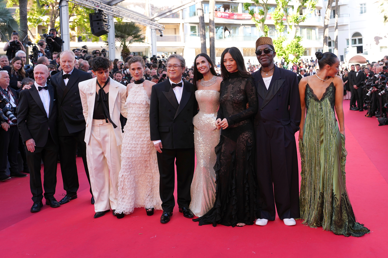 Jury president Park Chan-wook (center) poses with jury members (from left) Paul Laverty, Stellan Skarsgard, Diego Cespedes, Laura Wandel, Demi Moore, Chloe Zhao, Isaach de Bankole and Ruth Negga at the opening ceremony of the 79th Cannes Film Festival in France on Tuesday. (AP-Yonhap)