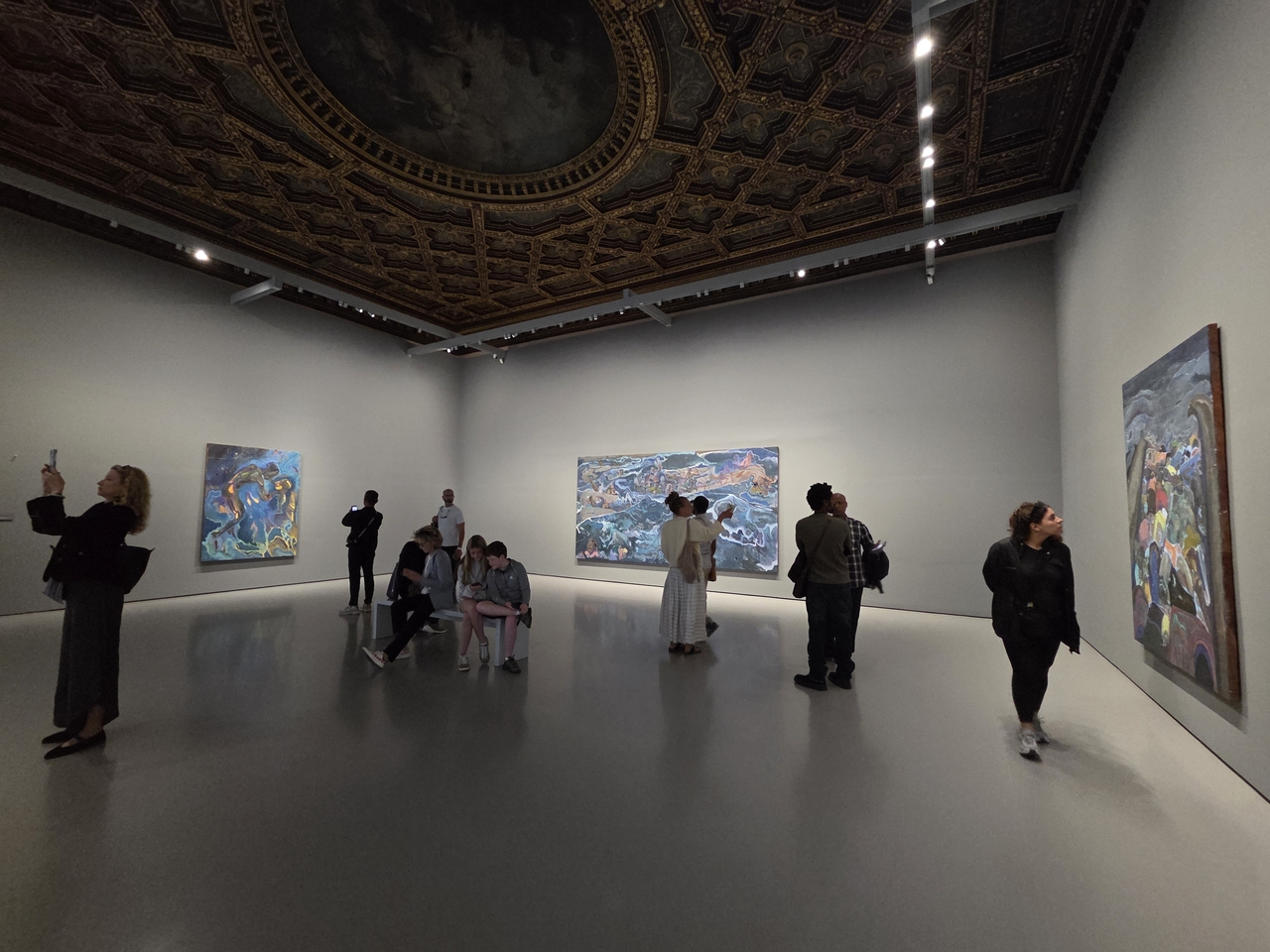 Visitors view the exhibition "Michael Armitage. The Promise of Change" at Palazzo Grassi in Venice, Italy, Friday. (Park Yuna/The Korea Herald)