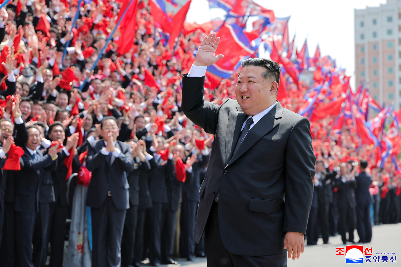 North Korean leader Kim Jong-un waves in Pyongyang on Thursday while joining a photo session with participants in the ninth congress of the General Federation of Trade Unions of Korea. (Korean Central News Agency)