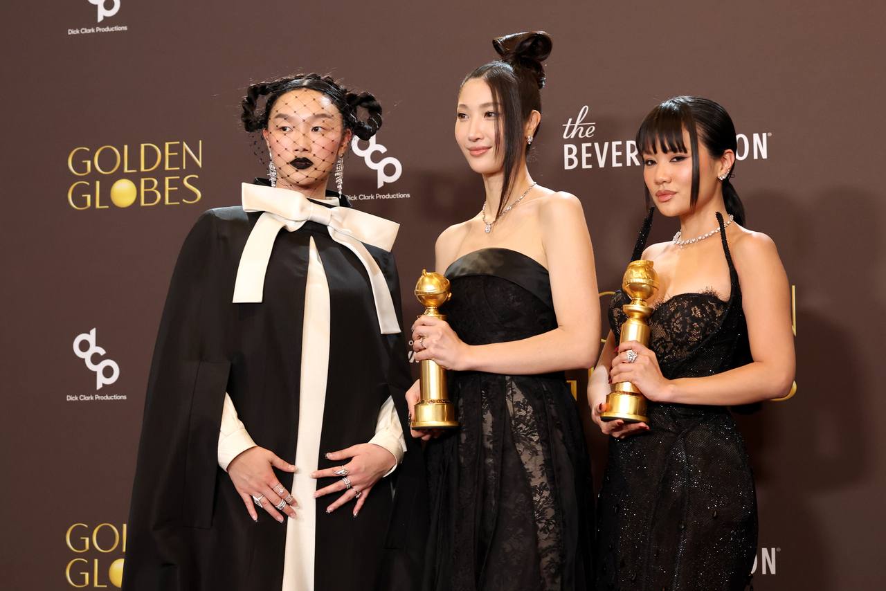 From left: Audrey Nuna, Ejae and Rei Ami pose with their award for best original song in a motion picture for "Golden" from "KPop Demon Hunters" at the 83rd Golden Globe Awards in Beverly Hills, California, on Jan 11. (Getty Images)